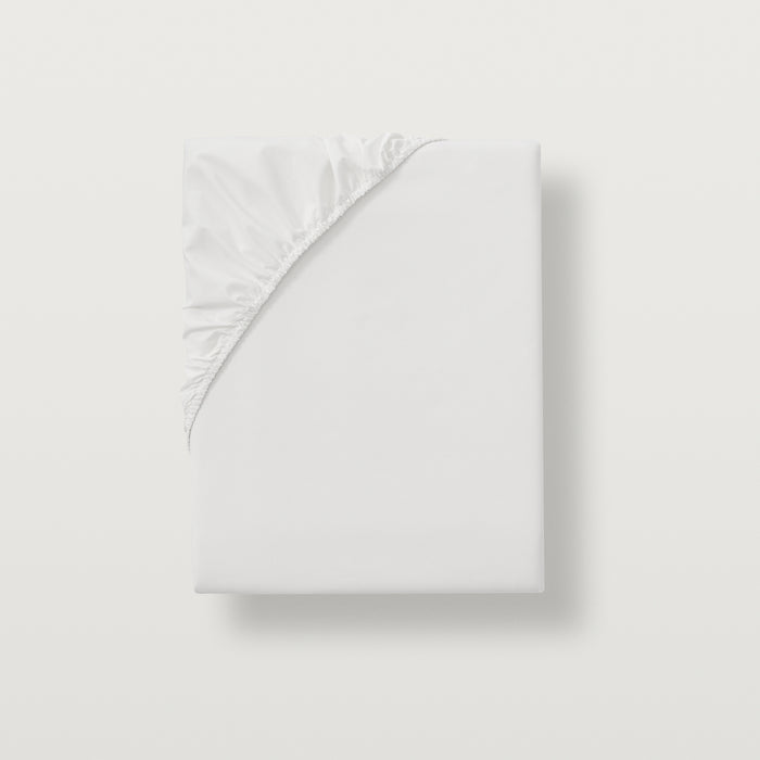 alesandra percale fitted sheet with all around sewen elastic skirt. Fits mattresses up to 17" deep #Color_white
