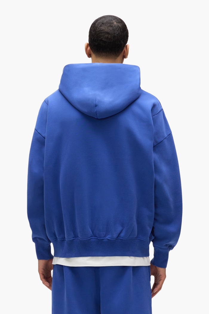 Basic Zip-Up Hoodie in blue, oversized fit, made of 100% cotton with dropped shoulders.