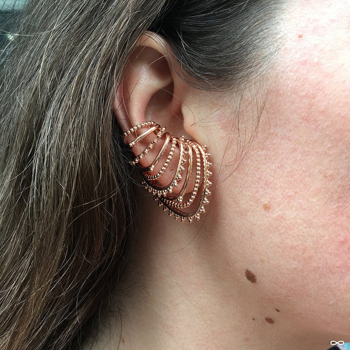 Model wearing Beaded Afghan Cuff from Tawapa in Rose-gold-plated Brass