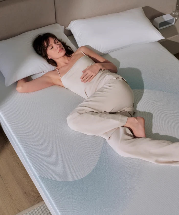 Breescape Cooling Mattress Topper for hot sleepers, woman enjoys cool, breathable sleep.