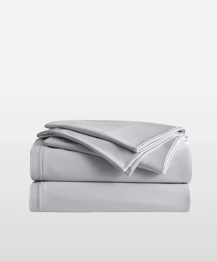 Misty grey Breescape cooling sheets for hot sleepers, showing texture and stitching.