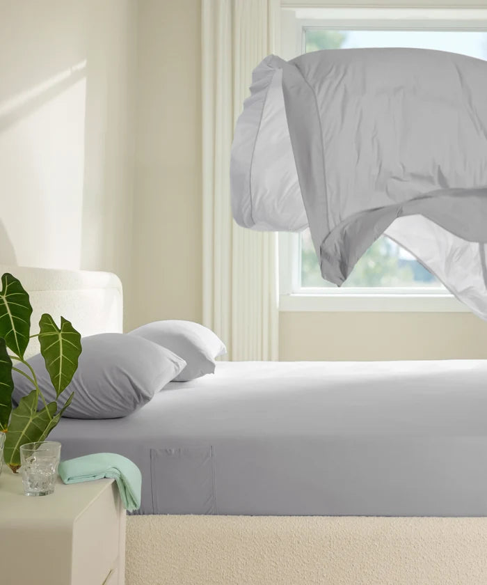 Breescape cooling sheets in misty grey, breathable fabric for hot sleepers with airy comforter.