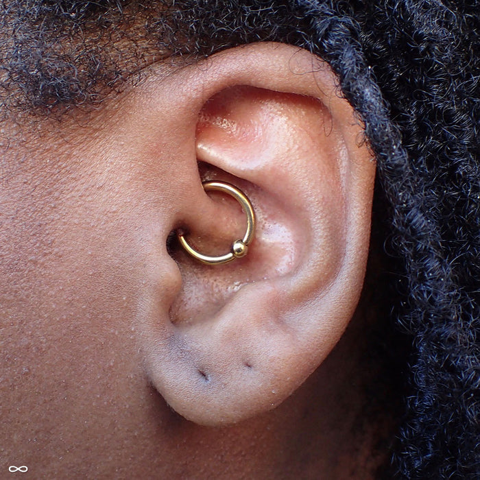 Daith piercing with Captive Bead Ring in Niobium from SM 316