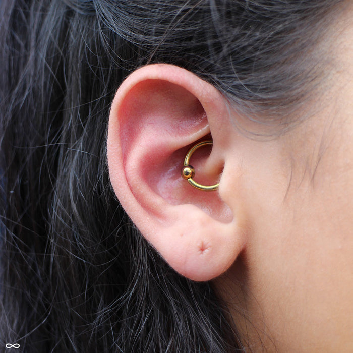 Daith piercing with Captive Bead Ring in Niobium from SM 316