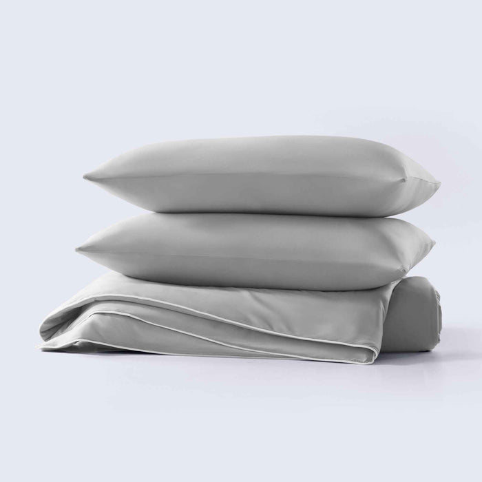 Stacked gray cooling pillow shams with soft cooling comforter