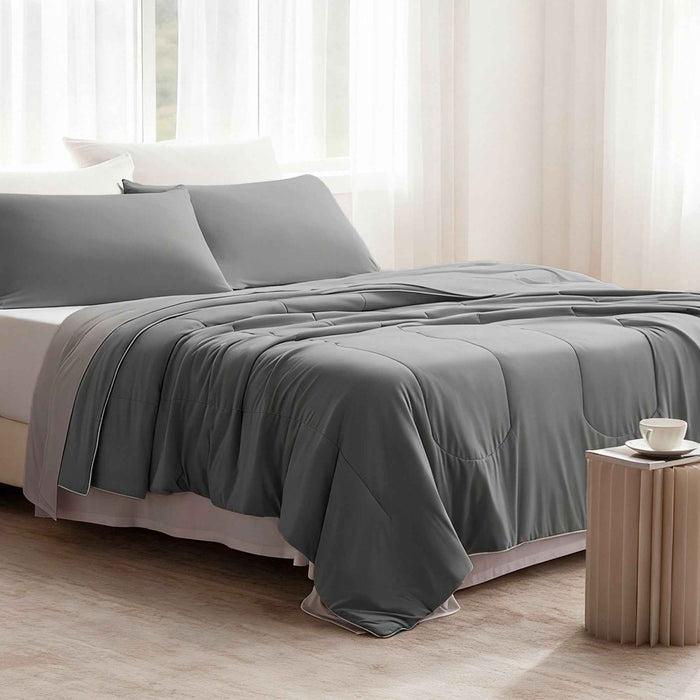 Gray cooling pillow shams styled with matching cooling comforter in a modern bedroom