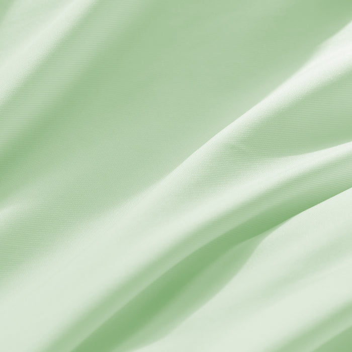 Close-up of smooth light green cooling pillowcase fabric