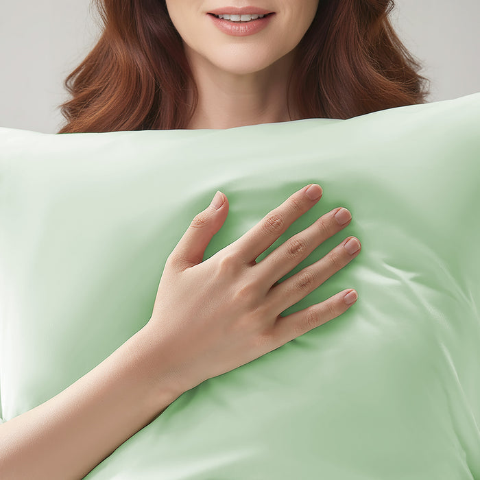 Woman resting on a light green cooling pillowcase for comfortable sleep