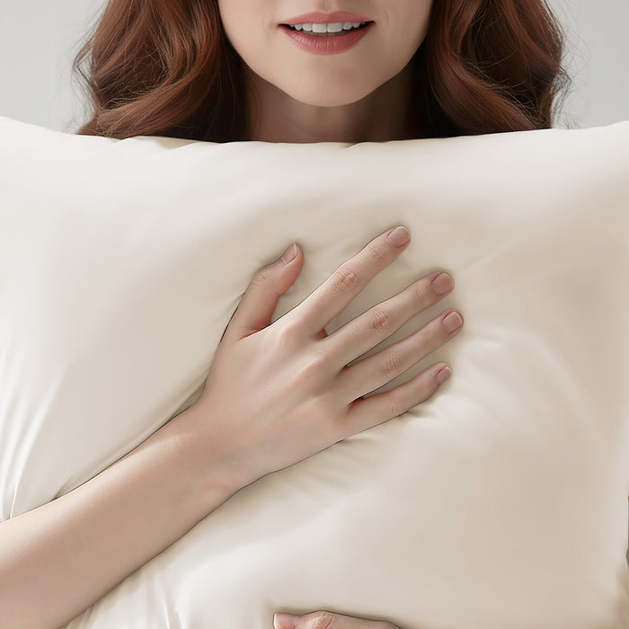 Woman resting on a beige cooling pillowcase for comfortable sleep