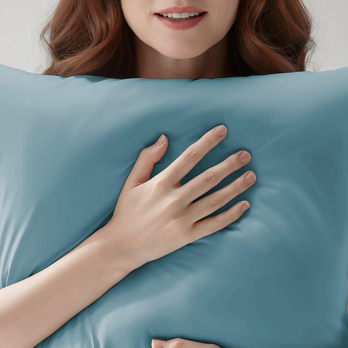Woman resting on a teal cooling pillowcase for comfortable sleep