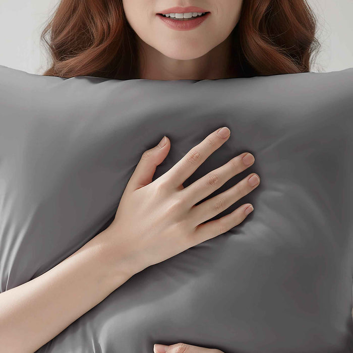 Woman resting on a dark gray cooling pillowcase for comfortable sleep