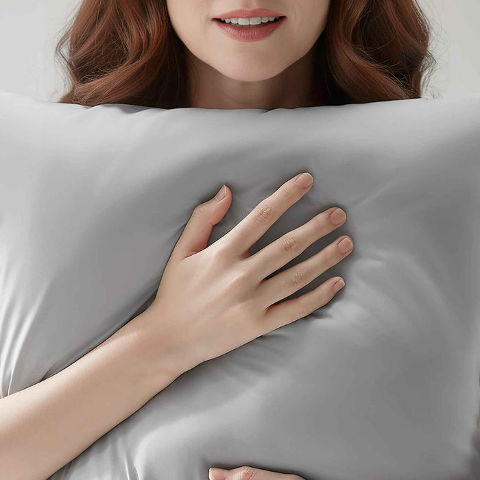 Woman resting on a gray cooling pillowcase for comfortable sleep