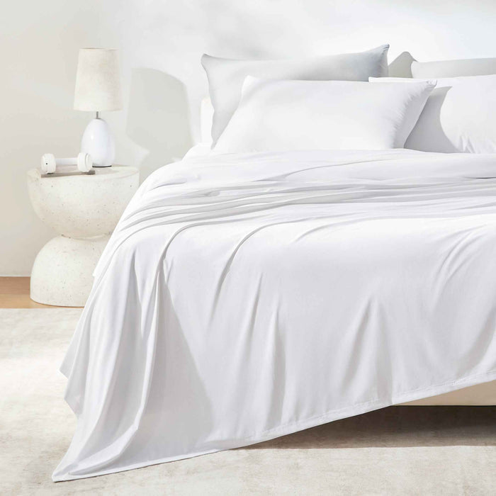 White cooling sheet set styled on a modern bed for hot sleepers