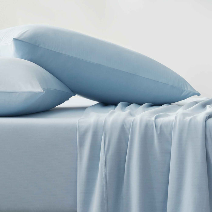 Blue cooling pillows and sheets with a smooth cool-to-the-touch finish