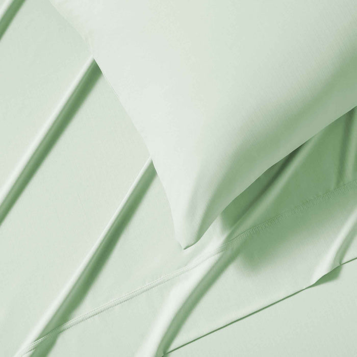 Close-up of green cooling sheet fabric with breathable temperature-regulating