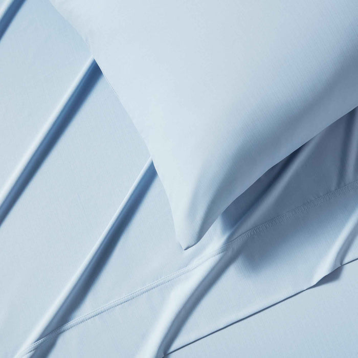 Close-up of blue cooling sheet fabric with breathable temperature-regulating layers