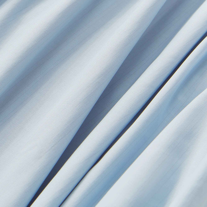 Close-up of silky blue cooling sheet fabric with moisture-wicking performance