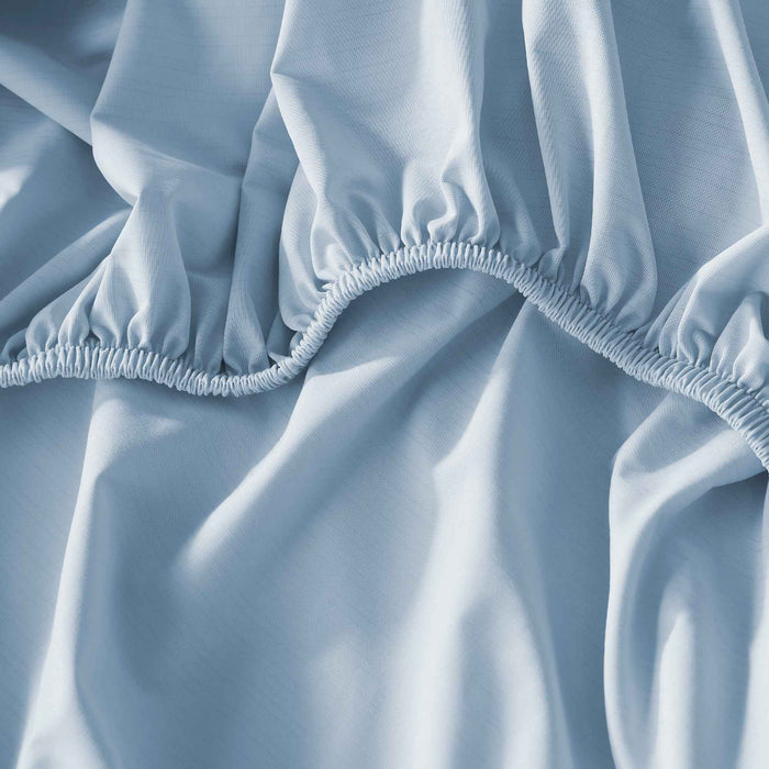 Blue cooling fitted sheet with elastic edging for a secure mattress fit