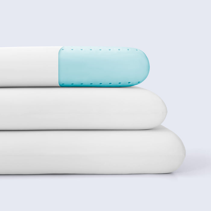 Stack of white cooling pillows against a white background