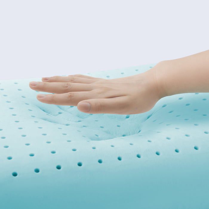 Hand on a blue gel pillow with a light gray background