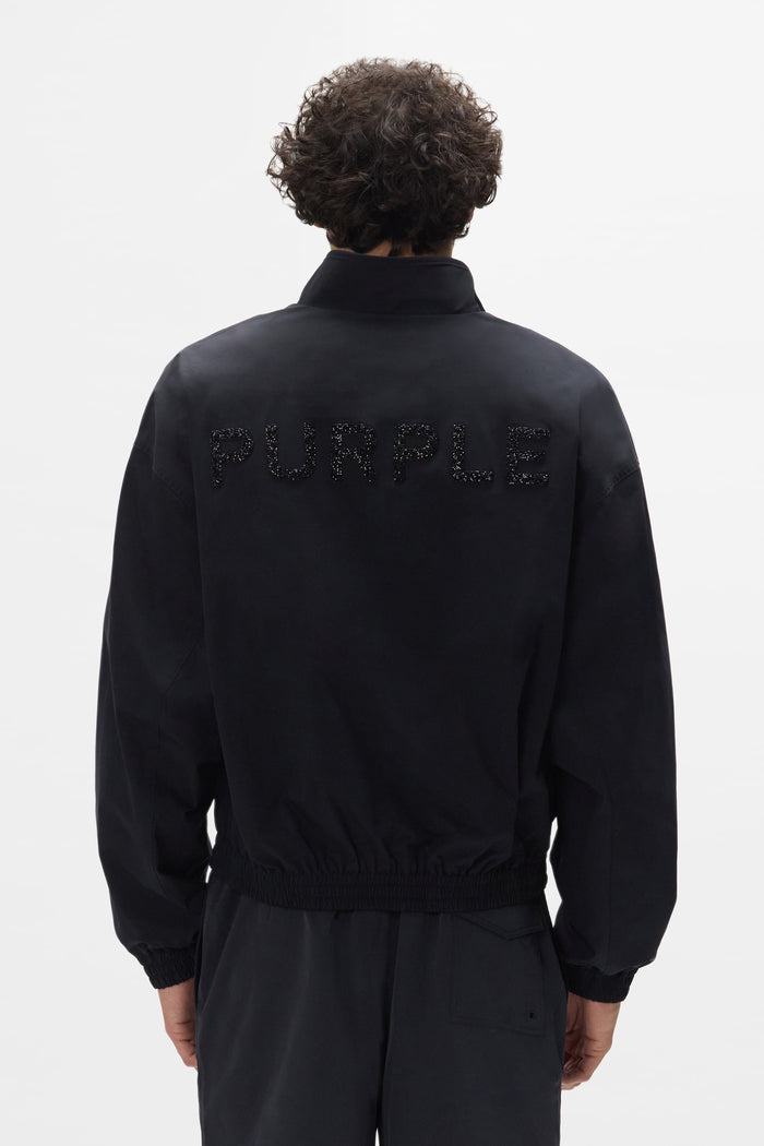 Crystal Wordmark Track Jacket with front zipper in relaxed fit, made of water-repellent polyester.