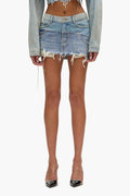 Double Denim Mini Skirt in indigo-washed denim with frayed hem and zip-fly closure.