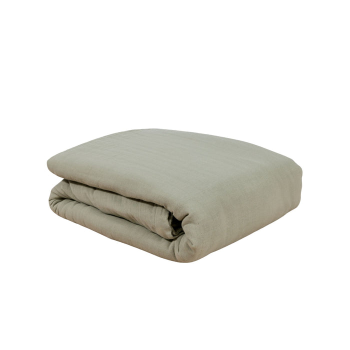A folded white duvet cover on a solid white background #color_forest canopy