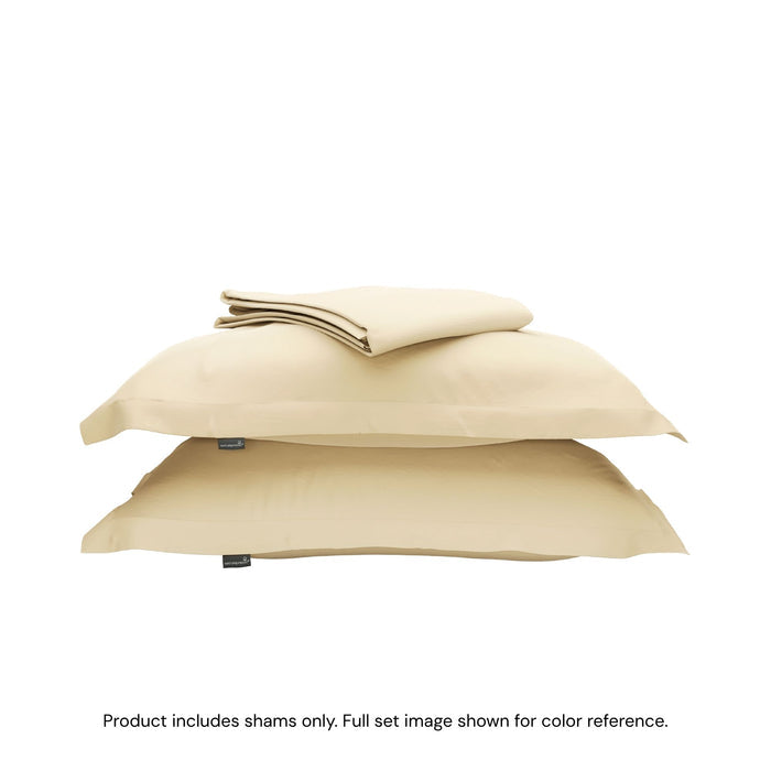 A duvet cover folded on top of two pillow shams #color_sunny