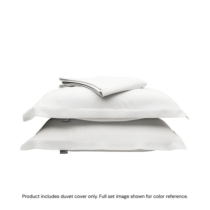 A folded duvet cover sitting on top of two pillow shams #color_arctic snow