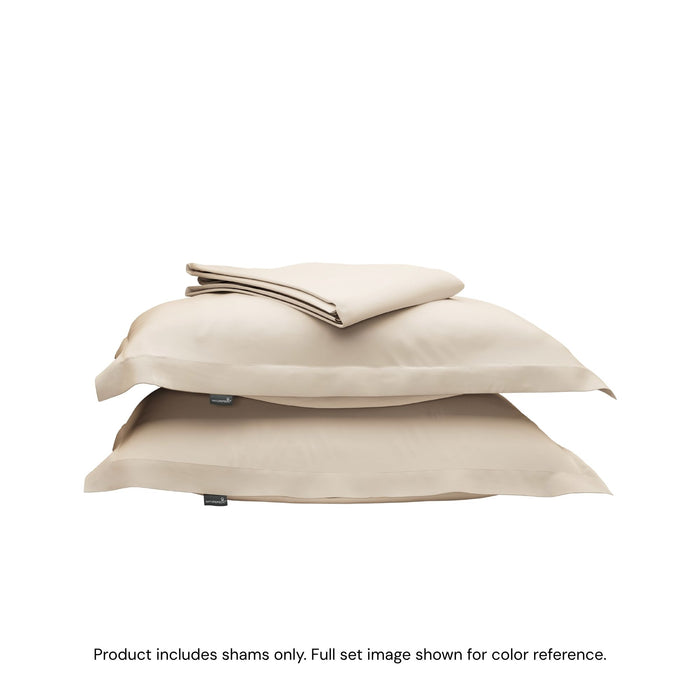 A folded duvet cover on top of two pillow shams. #color_undyed