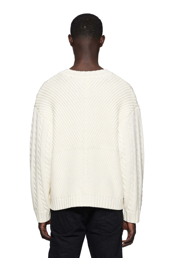 Gothic P Cable Knit Sweater in white with crewneck and rolled edges, made from 100% merino wool.