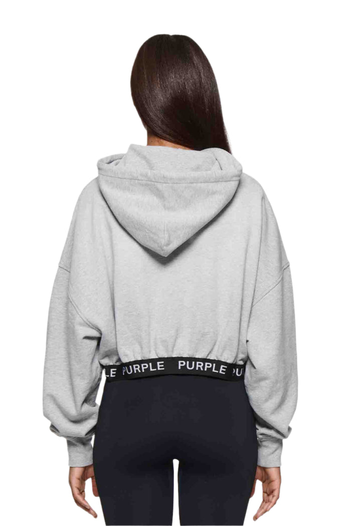 Grey cropped hoodie with dropped shoulders and purple logo detailing, available in multiple sizes.