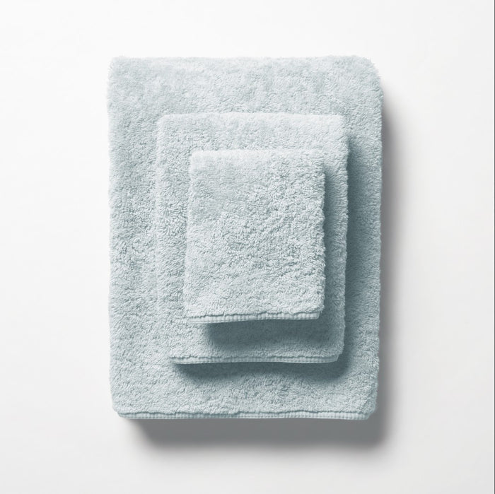 scandia home's indulgence wash, hand, and bath towel folded in the color glacier #color_glacier