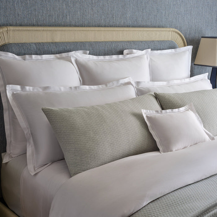 close up detail of Lucea's double hemstitch finish shams in white along side Ravello cove shams.