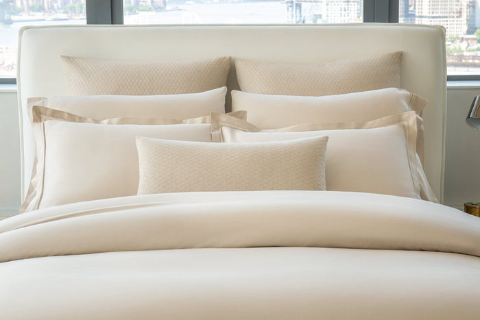 Paired Lucea Fawn pillowcases and shams with Ravello shams in the color linen