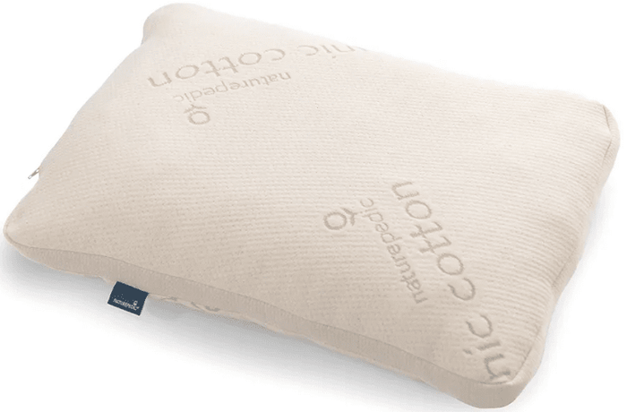 The Naturepedic Organic Adjustable Latex Pillow is a rectangular beige pillow made from organic cotton, featuring "Naturepedic" and "organic cotton" embroidery and a small blue fabric tag on the side.
