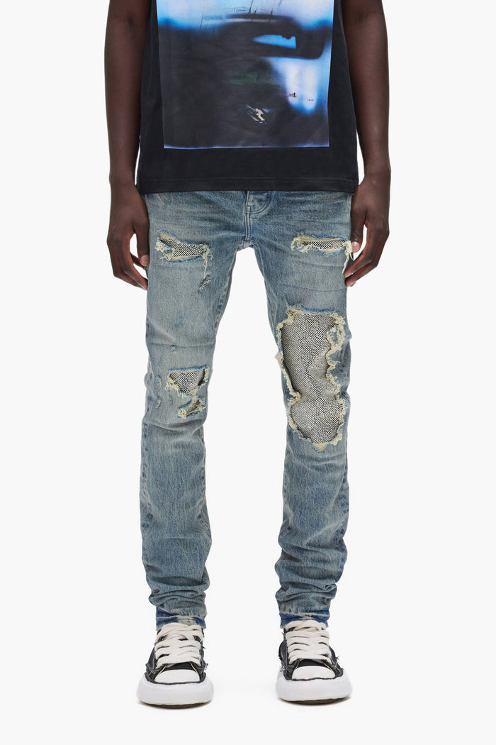 Beaded Repair low rise denim with silver patches in sizes 28 to 40, made of premium stretch fabric.