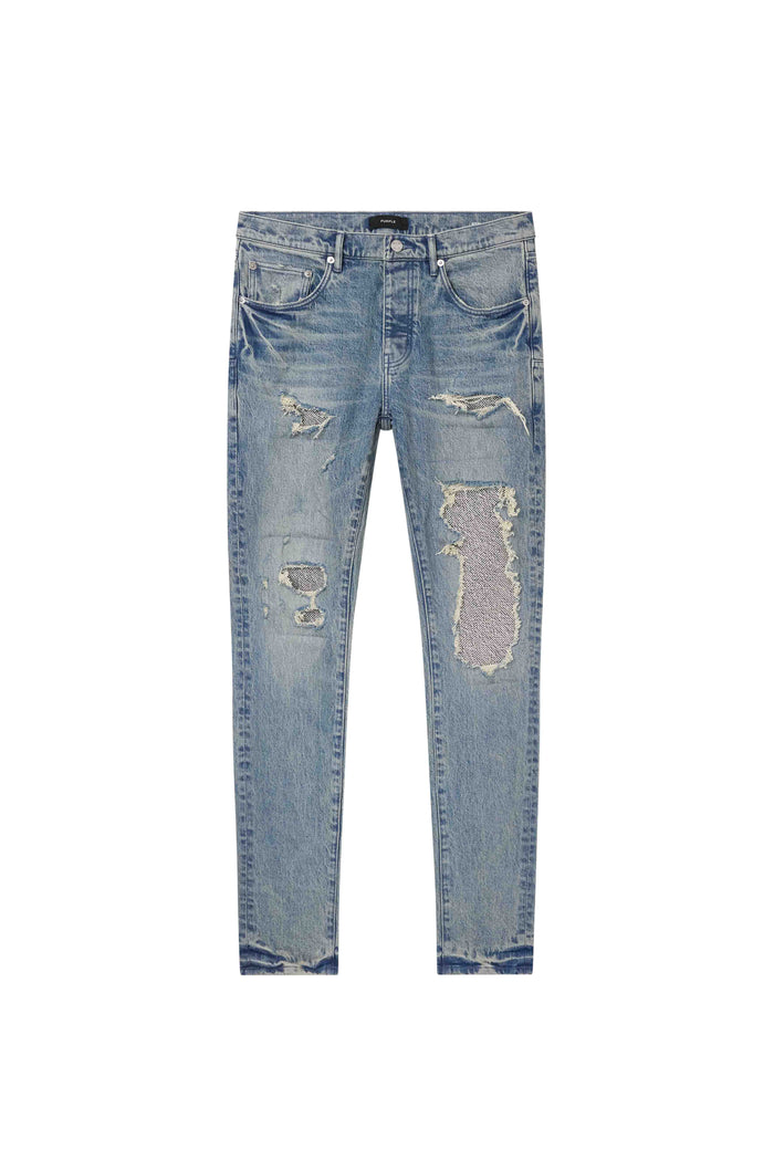 Skinny Beaded Repair Denim in Light Indigo with silver beaded patches and surface abrasions.