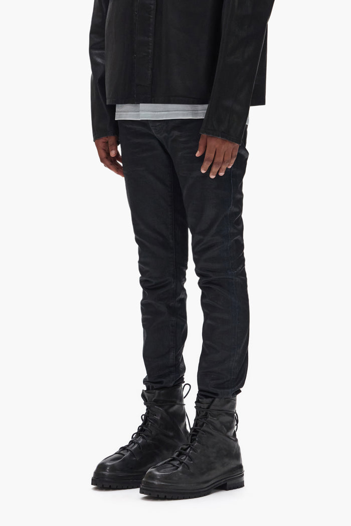 Coated denim jeans in indigo with black coating, featuring a low rise and premium stretch fabric.