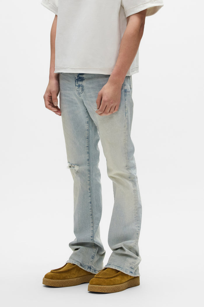 Slim fit flared leg denim with knee blowouts, part of the Spring Summer 2026 collection.