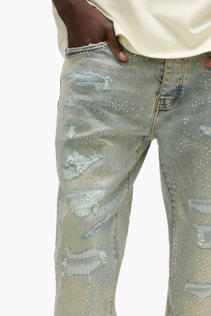 Light Indigo P004 Crystal Repair Slim Fit Flared Leg Denim Jeans with repairs and button fly.