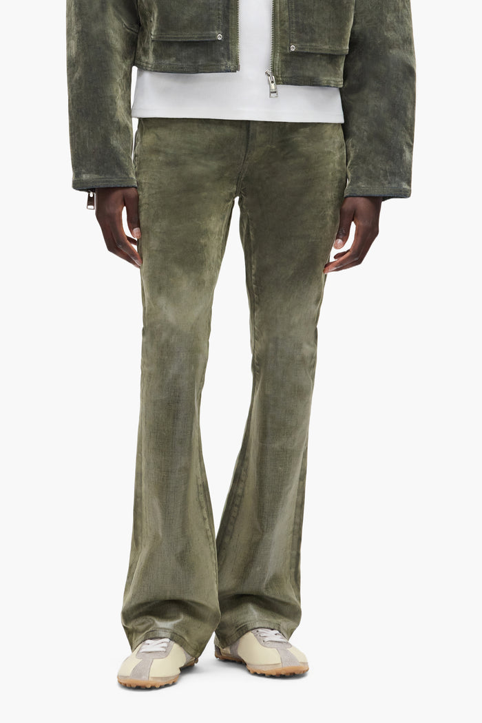 Flock Dipped denim with flared leg in green, low rise, slim fit, and 5 pocket styling.