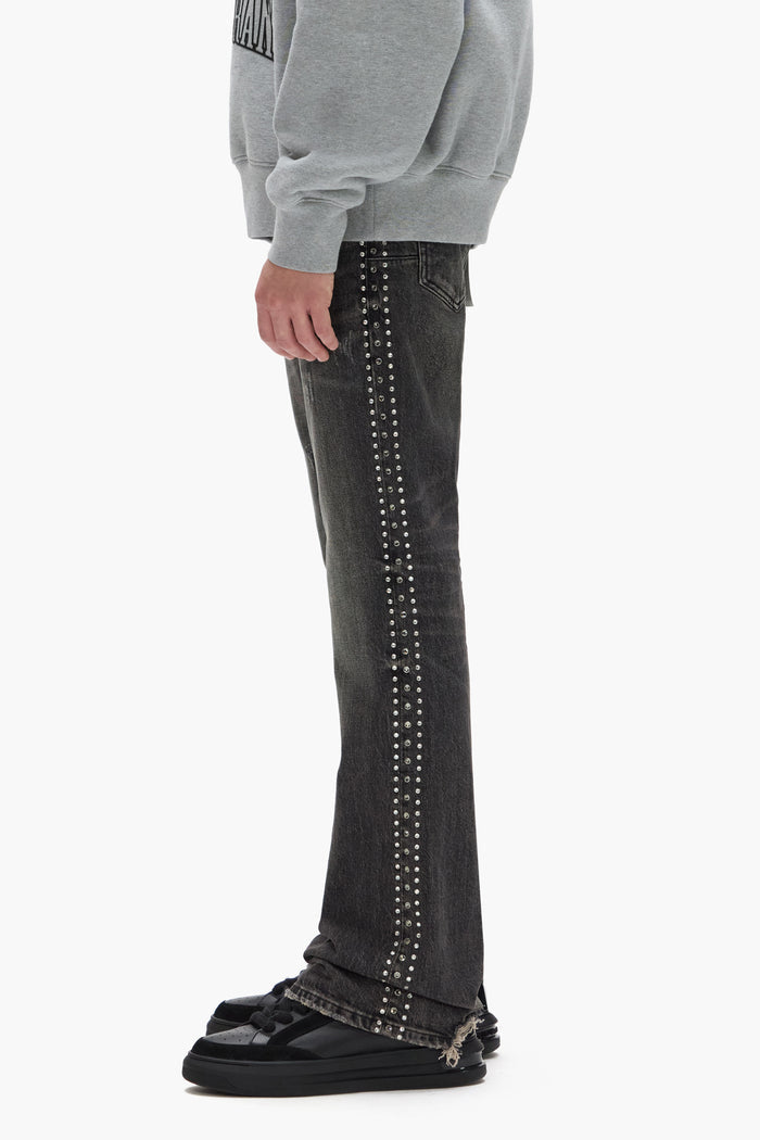 Faded low rise boot-cut denim with side crystals, dirty black wash, sizes 28-40.