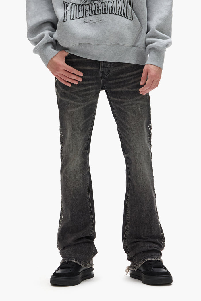 Faded low rise boot-cut denim with side crystals and chewed hem in vintage dirty black wash.