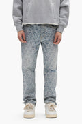A person wears a gray sweatshirt, white sneakers, and PURPLE BRAND P011 Jacquard Monogram light blue mid-rise straight leg jeans. They stand facing forward with hands at their sides; only their body from shoulders to feet is visible.