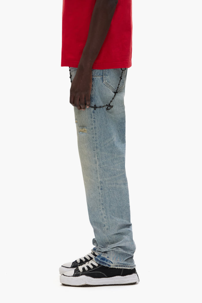 P011 Knee Blowout men’s denim jeans in dirty light indigo wash with large knee tear.