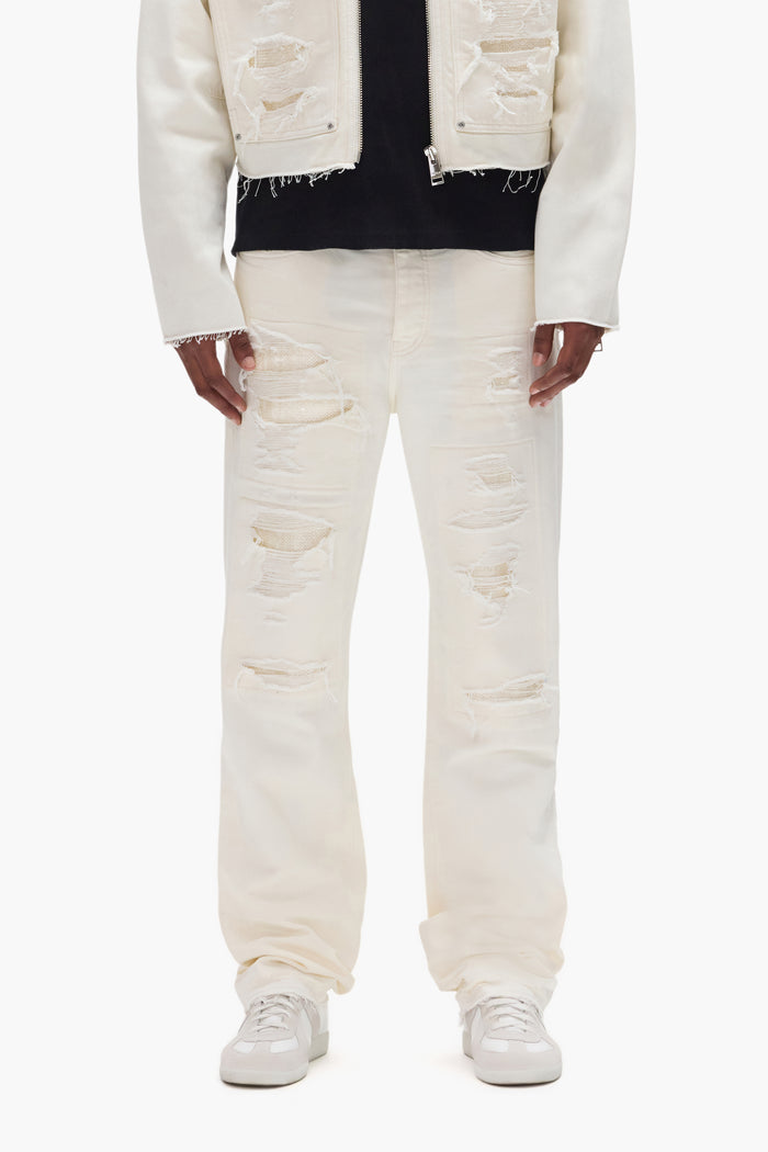 P011 Patch Blowout mid-rise straight leg denim with repairs and sequins in various sizes.