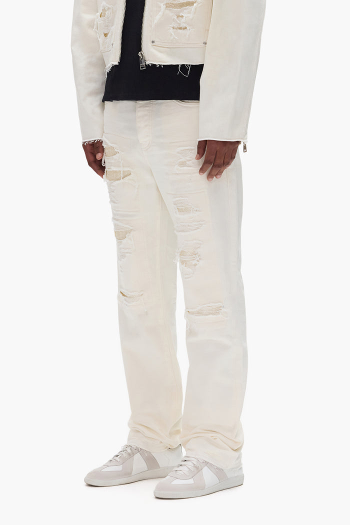 P011 Patch Blowout premium stretch denim mid rise straight leg with repairs and sequins.