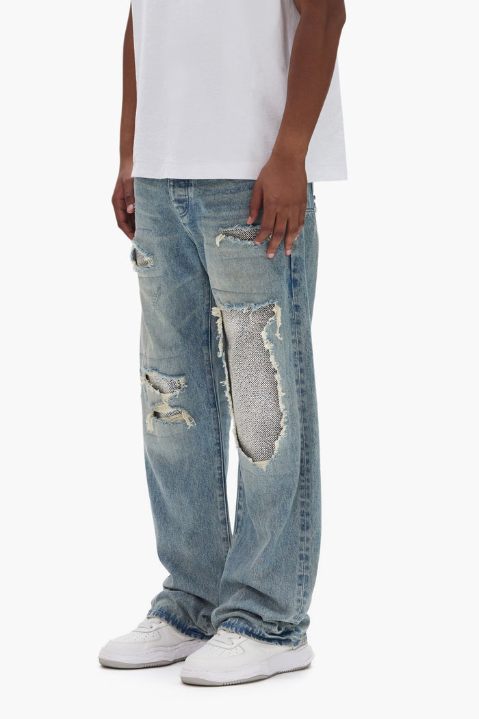 Beaded Repair mid-rise denim with patches, available in sizes 28-40, featuring 5 pocket styling.