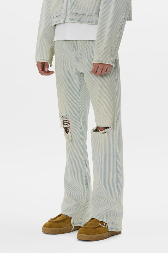 Hickory stripe bootcut denim jeans with knee blowouts and sharkbite hem, mid-rise style.